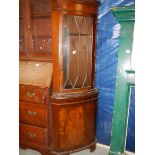 A mahogany corner cupboard.