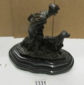 A bronze figure of game hunter with dog.