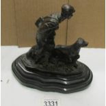 A bronze figure of game hunter with dog.