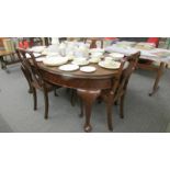 A good quality oval wind out dining table with four chairs.