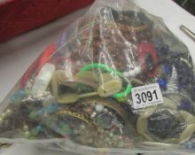 A large bag of assorted costume jewellery, approximately 3.5 kilos.
