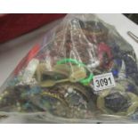 A large bag of assorted costume jewellery, approximately 3.5 kilos.