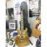 A USA Gold Gibson "Classic" Les Paul left hand guitar with original hard case.