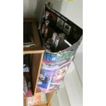 A large collection of modern day posters in a display box.