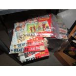 A quantity of empty Beatles jigsaw boxes.