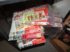 A quantity of empty Beatles jigsaw boxes.