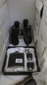 A hip flask set and binoculars.