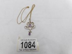A 9ct gold pendant necklace set amethyst and seed pearls on 9ct gold chain,.