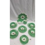 A green floral patterned china tea set (missing 1 tea plate).