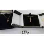 2 9ct gold cross pendants on chains, each set with a diamond chip, (9 grams).