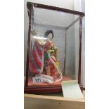 A Japanese doll in case.