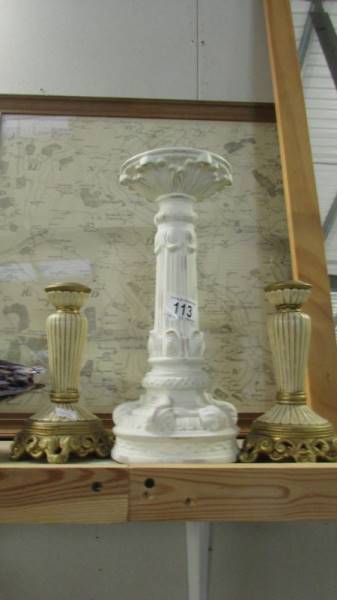 A pair of candlesticks and one other.