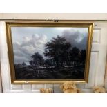 A gilt framed forest scene