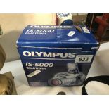 An Olympus IS-5000 all in one camera, runs on rechargable batteries (charger not included).