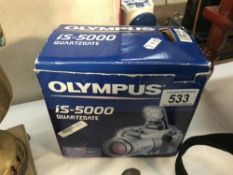 An Olympus IS-5000 all in one camera, runs on rechargable batteries (charger not included).