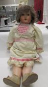 A 19ty century porcelain headed doll with 'Mama', marked Amuso 1012/13,