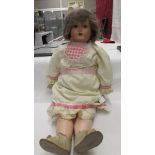 A 19ty century porcelain headed doll with 'Mama', marked Amuso 1012/13,