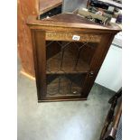 An oak wall corner cabinet