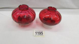 A pair of reproduction oil lamp peg fonts.