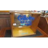 A glazed cabinet bearing Gillette Blue Blades & Razors, Made in USA signage.