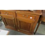 A 2 drawer, 2 door mahogany cabinet.