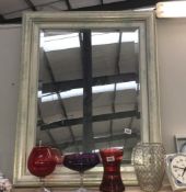 A large silvered bevelled mirror