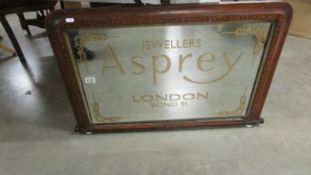 A mirror bearing Aspray Jewellers London signage.