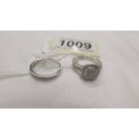 A matching set of 2 white gold and diamond rings, size M.