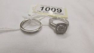 A matching set of 2 white gold and diamond rings, size M.