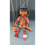 A vintage wooden Pinochio string puppet.