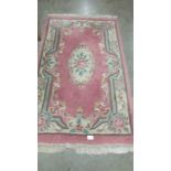 A pink wool rug.