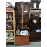 A 1970's 'JS' satcol teak wall unit with smoke glass doors