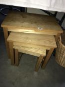 A nest of three pine tables