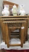 A good quality nest of 3 carved oak tables.