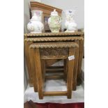 A good quality nest of 3 carved oak tables.