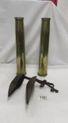 An 18th century wax/oil burner and 2 brass gun shells.