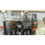 3 shelves of assorted glass ware.