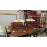 A mahogany extending dining table with one extra leaf and a set of 6 dining chairs.