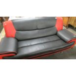 A retro sofa in red and black (small tear on front - see image).