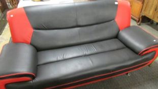 A retro sofa in red and black (small tear on front - see image).