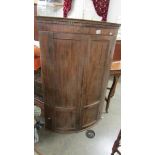 A mahogany corner cupboard.