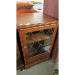 An oak lead glazed music cabinet.