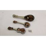 3 tortoise shell inlaid musical instruments, mandolin, guitar and banjo.