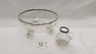 A silver rimmed glass bowl and a small silver rimmed jug.