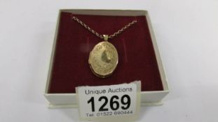 A 9ct gold locket on chain, (8.8 grams).