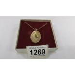 A 9ct gold locket on chain, (8.8 grams).