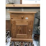 A pine bedside cabinet