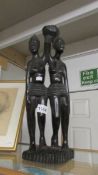 A carved figure group of 2 African women.