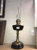 A Victorian oil lamp with brass column & glass font