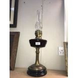 A Victorian oil lamp with brass column & glass font